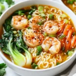 Die Zutaten für die Spicy Shrimp Ramen Bowls sind einfach und frisch. Hier sind die Hauptbestandteile, die Sie brauchen: - 200 g Ramen-Nudeln - 300 g große Garnelen, geschält und entdarmt - 1 Liter Gemüsebrühe - 2 Esslöffel Sojasauce - 1 Esslöffel Sesamöl - 1 Esslöffel Chilipaste (nach Geschmack anpassen) - 1 Teelöffel frischer Ingwer, gerieben - 2 Knoblauchzehen, fein gehackt - 1 Tasse Bok Choy, grob gehackt - 1 Karotte, in feine Streifen geschnitten (julienne) - 2 Frühlingszwiebeln, in Ringe geschnitten - 1 Esslöffel Sesamsamen - Frischer Koriander zum Garnieren Diese Zutaten sorgen für einen tollen Geschmack und eine schöne Textur. Wenn Sie bestimmte Zutaten nicht mögen oder nicht finden können, gibt es viele Alternativen: - Verwenden Sie Reisnudeln statt Ramen-Nudeln. - Garnelen können durch Hühnchen oder Tofu ersetzt werden. - Statt Gemüsebrühe können Sie Hühnerbrühe verwenden. - Für mehr Schärfe fügen Sie mehr Chilipaste hinzu oder nutzen Sie frische Chilis. Diese Anpassungen machen das Gericht flexibel für jeden Geschmack. Die Spicy Shrimp Ramen Bowls sind nicht nur lecker, sondern auch gesund. Hier sind einige Vorteile: - Garnelen sind reich an Protein und niedrig in Kalorien. - Gemüse wie Bok Choy und Karotten bieten viele Vitamine und Mineralstoffe. - Ingwer und Knoblauch fördern die Verdauung und das Immunsystem. - Die Brühe ist hydrierend und kann helfen, den Körper zu reinigen. Genießen Sie diese Bowl als nahrhafte Option für eine schnelle Mahlzeit! {{ingredient_image_2}} Um die Ramen-Nudeln zuzubereiten, bringen Sie einen großen Topf mit Wasser zum Kochen. Fügen Sie die 200 g Ramen-Nudeln hinzu. Kochen Sie sie gemäß der Packungsanweisung. Dies dauert meist etwa 3-5 Minuten. Wenn die Nudeln weich sind, gießen Sie sie ab und stellen sie beiseite. Es ist wichtig, die Nudeln nicht zu lange zu kochen, da sie sonst matschig werden. Erhitzen Sie 1 Esslöffel Sesamöl in einem großen Topf bei mittlerer Hitze. Fügen Sie 2 fein gehackte Knoblauchzehen und 1 Teelöffel geriebenen Ingwer hinzu. Braten Sie sie für etwa 1 Minute an, bis sie duften. Geben Sie dann 300 g große Garnelen in den Topf. Braten Sie die Garnelen für 2-3 Minuten, bis sie rosa und undurchsichtig sind. Gießen Sie 1 Liter Gemüsebrühe, 2 Esslöffel Sojasauce und 1 Esslöffel Chilipaste in den Topf. Rühren Sie alles gut um und lassen Sie es sanft köcheln. Fügen Sie 1 Tasse grob gehackten Bok Choy und 1 in feine Streifen geschnittene Karotte hinzu. Lassen Sie alles weitere 3-4 Minuten köcheln, bis das Gemüse zart ist. Teilen Sie die gekochten Ramen-Nudeln auf zwei Schalen auf. Löffeln Sie die würzige Garnelen- und Brühenmischung über die Nudeln. Garnieren Sie jede Schale mit 2 geschnittenen Frühlingszwiebeln, 1 Esslöffel Sesamsamen und frischem Koriander. Für mehr Geschmack können Sie zusätzlich ein wenig Sesamöl darüber träufeln. Ein Limettenviertel an die Seite zu legen, bringt einen spritzigen Kick in die Bowls. Um perfekte Garnelen zu machen, achte auf die Frische. Verwende große, frische Garnelen. Du kannst sie leicht mit Knoblauch und Ingwer anbraten. Brate sie nur 2-3 Minuten, bis sie rosa sind. So bleiben sie saftig und zart. Übertreibe es nicht beim Kochen, sonst werden sie hart. Die Chilipaste ist wichtig für den Geschmack. Beginne mit einem Esslöffel. Rühre die Paste gut in die Brühe ein. Probiere die Brühe, während sie köchelt. Wenn du mehr Schärfe magst, füge mehr Chilipaste hinzu. Achte darauf, die Schärfe langsam zu steigern. So bekommst du die perfekte Balance. Präsentiere deine Ramen in tiefen Schalen. Das schafft einladende Portionen. Garniere mit geschnittenen Frühlingszwiebeln und Sesamsamen. Frischer Koriander bringt Farbe und Geschmack. Ein Limettenviertel daneben sorgt für einen spritzigen Kick. Diese kleinen Details machen dein Gericht besonders ansprechend. Pro Tipps Frische Garnelen verwenden: Verwenden Sie frische oder gefrorene Garnelen, um den besten Geschmack und die beste Textur in Ihren Ramen zu erzielen. Gemüsevariationen: Experimentieren Sie mit verschiedenen Gemüsesorten wie Spinat, Zucchini oder Erbsen, um Abwechslung und zusätzliche Nährstoffe zu bieten. Chilipaste anpassen: Passen Sie die Menge der Chilipaste nach Ihrem persönlichen Schärfewunsch an, um das Gericht nach Ihrem Geschmack zu gestalten. Servierempfehlung: Servieren Sie die Ramen mit einem Spritzer Limettensaft für eine erfrischende Note und zusätzlichen Geschmack. {{image_4}} Für eine vegetarische Variante der Spicy Shrimp Ramen Bowls können Sie Tofu verwenden. Schneiden Sie den Tofu in Würfel und braten Sie ihn goldbraun an. Ersetzen Sie die Brühe durch eine Gemüsebrühe. Fügen Sie mehr Gemüse wie Pilze oder Zucchini hinzu. Für eine vegane Option verwenden Sie Kokosnussmilch, um eine cremige Basis zu schaffen. Sojasauce bleibt eine großartige Ergänzung für den Geschmack. Gemüse macht Ihre Ramen-Bowls noch besser. Fügen Sie Erbsen, Spinat oder Paprika hinzu. Diese Zutaten bringen Farbe und Nährstoffe. Brokkoli und Zuckerschoten sind ebenfalls gut. Sie sind einfach zuzubereiten und passen gut zu den anderen Aromen. Experimentieren Sie mit verschiedenen Gemüsesorten, um Ihren persönlichen Favoriten zu finden. Toppings machen Ihre Ramen-Bowls besonders lecker. Fügen Sie ein gekochtes Ei für mehr Protein hinzu. Chilipulver steigert die Schärfe. Frische Kräuter wie Koriander oder Basilikum geben einen frischen Geschmack. Geröstete Nüsse oder Samen sorgen für einen tollen Crunch. Denken Sie daran, etwas Limettensaft darüber zu träufeln. Das bringt die Aromen zusammen und macht das Gericht noch besser. Lagern Sie die Ramen-Nudeln und Brühe getrennt. Verwenden Sie luftdichte Behälter. Die Brühe bleibt frisch im Kühlschrank bis zu drei Tage. Die Ramen-Nudeln sollten Sie in einem trockenen Ort aufbewahren. Um die Ramen wieder aufzuwärmen, benutzen Sie einen Topf. Fügen Sie etwas Wasser oder Brühe hinzu. Erhitzen Sie alles bei mittlerer Hitze. Rühren Sie oft, damit nichts anbrennt. Die Garnelen sollten nicht zu lange erhitzt werden, um ihre Zartheit zu bewahren. Die vorbereiteten Zutaten sind unterschiedlich haltbar. Die gekochten Garnelen halten sich zwei Tage im Kühlschrank. Frisches Gemüse wie Bok Choy bleibt bis zu drei Tage frisch. Achten Sie auf das Verfallsdatum der Sojasauce und der Chilipaste. Die Ramen sind im Kühlschrank drei Tage haltbar. Achten Sie darauf, die Ramen und Brühe getrennt zu lagern. So bleibt die Textur der Nudeln besser erhalten. Nach drei Tagen empfehle ich, die Ramen nicht mehr zu essen. Ja, gefrorene Garnelen sind eine gute Option. Sie lassen sich leicht verwenden. Achten Sie darauf, sie vorher gut aufzutauen. So werden sie gleichmäßig gekocht. Um die Schärfe zu verringern, verwenden Sie weniger Chilipaste. Sie können auch einen Löffel Honig hinzufügen. Das mildert die Schärfe und bringt eine süße Note. Ja, es gibt glutenfreie Ramen-Nudeln. Sie sind aus Reis oder Buchweizen hergestellt. Diese Alternativen sind gut für glutenfreie Ernährung geeignet. Achten Sie beim Kauf auf die Verpackung. Spicy Shrimp Ramen Bowls sind einfach und lecker. Wir haben die Hauptzutaten, Alternativen und Nährwerte besprochen. Die Schritt-für-Schritt-Anleitung macht die Zubereitung unkompliziert. Tipps helfen dir, perfekte Garnelen zu kochen und ansprechend zu servieren. Denke an die Variationen mit Gemüse und Toppings für mehr Geschmack. Bewahrung und Aufwärmung der Ramen sind auch wichtig. Denke immer an die Antworten auf häufige Fragen. Jetzt bist du bereit, deine eigenen köstlichen Ramen-Bowls zu machen!